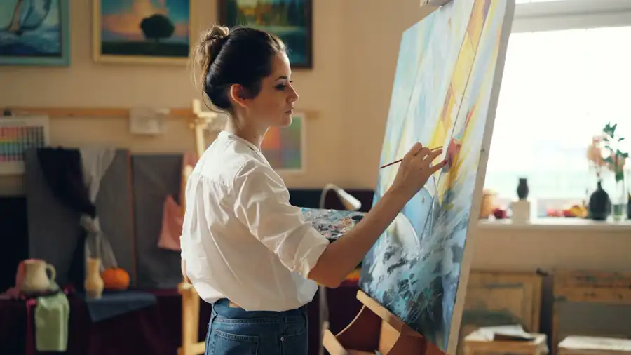 A woman painting in her studio